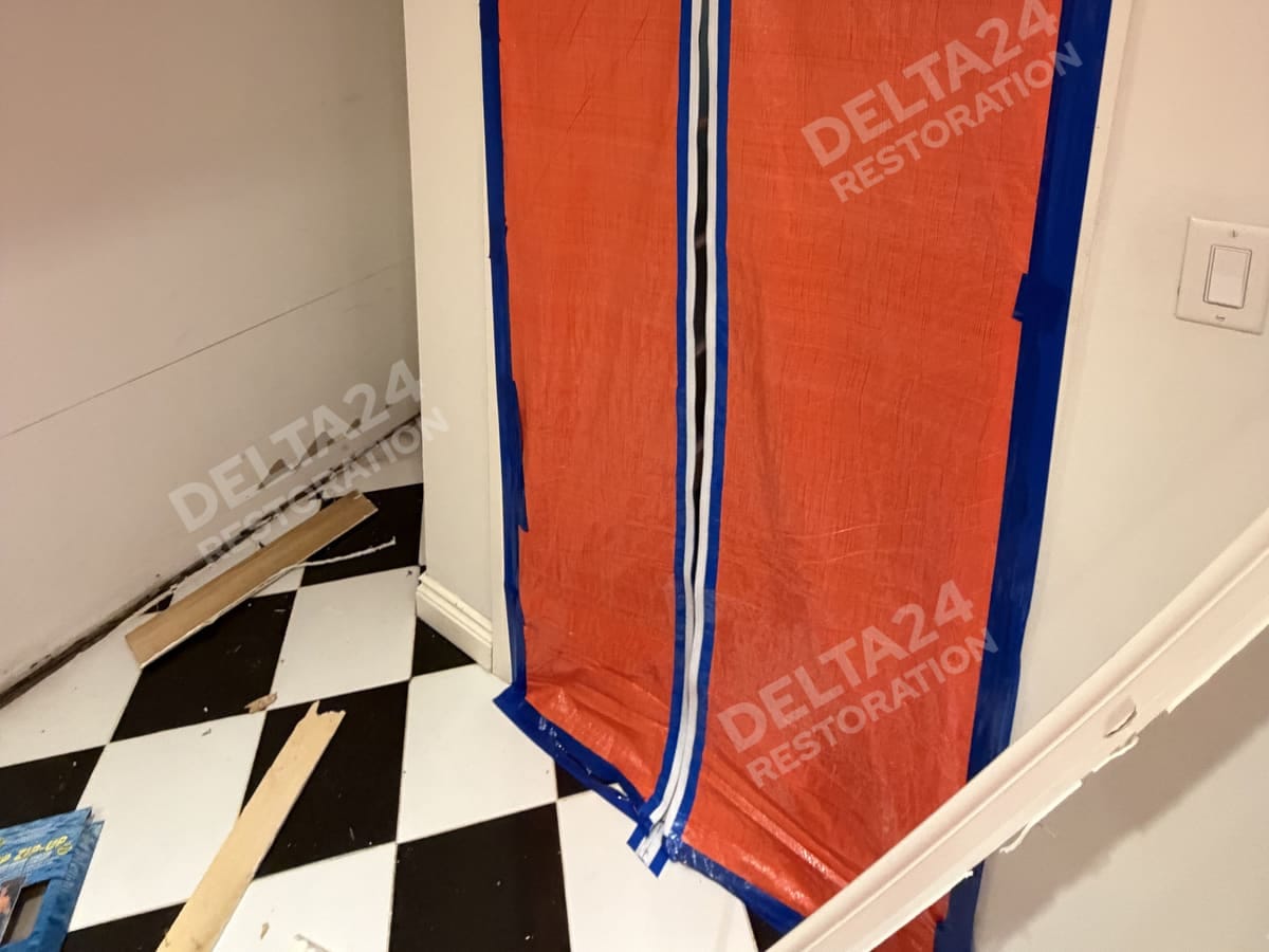 The zippered containment door sealing off the utility room